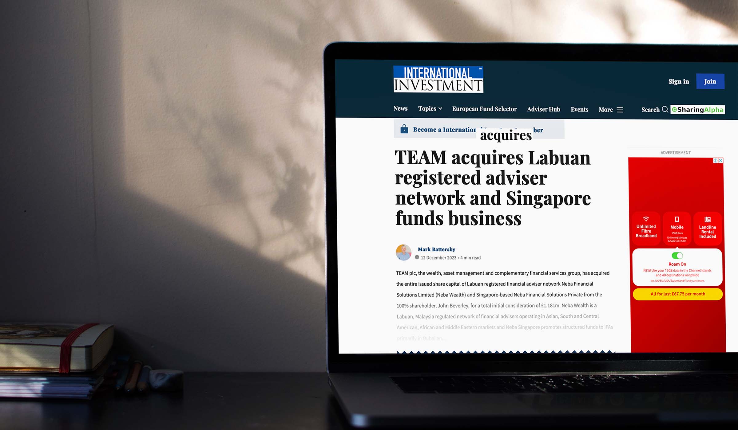 Laptop showing International Investment coverage of TEAM acquiring a Labuan adviser network and Singapore funds business