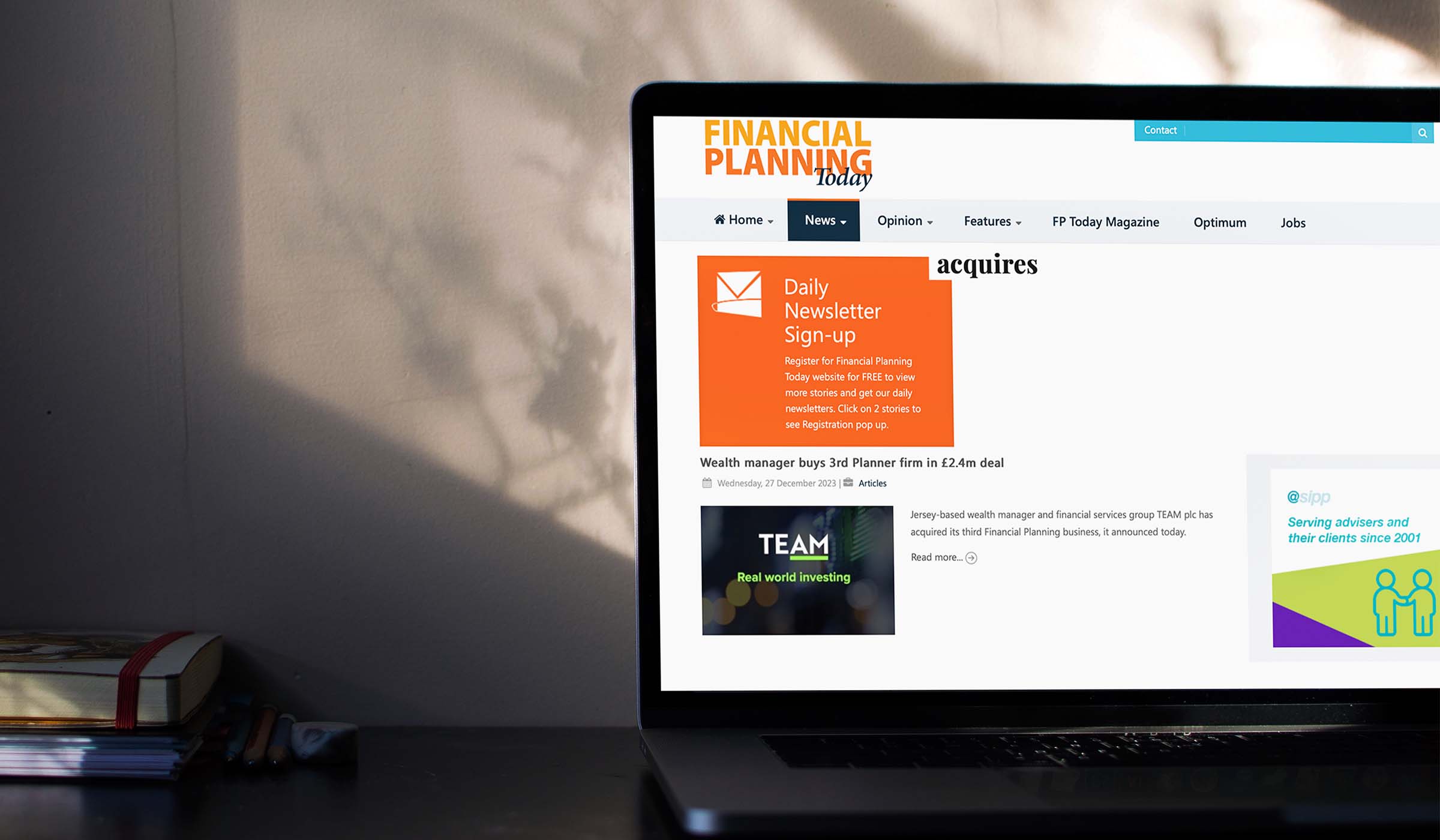 Laptop showing Financial Planning Today coverage of TEAM's £2.4 million planning firm deal