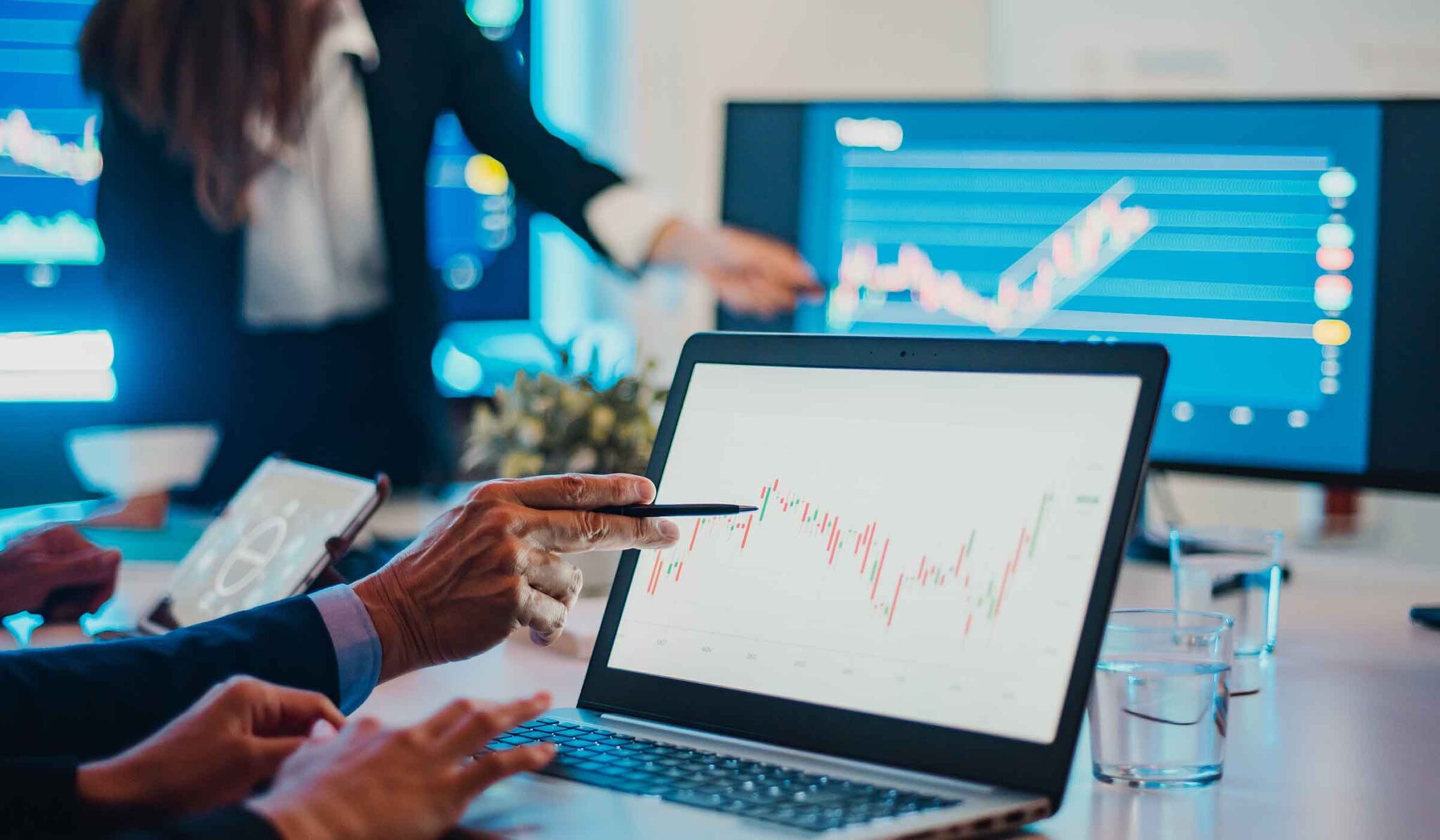 Investors reviewing share price charts on a laptop